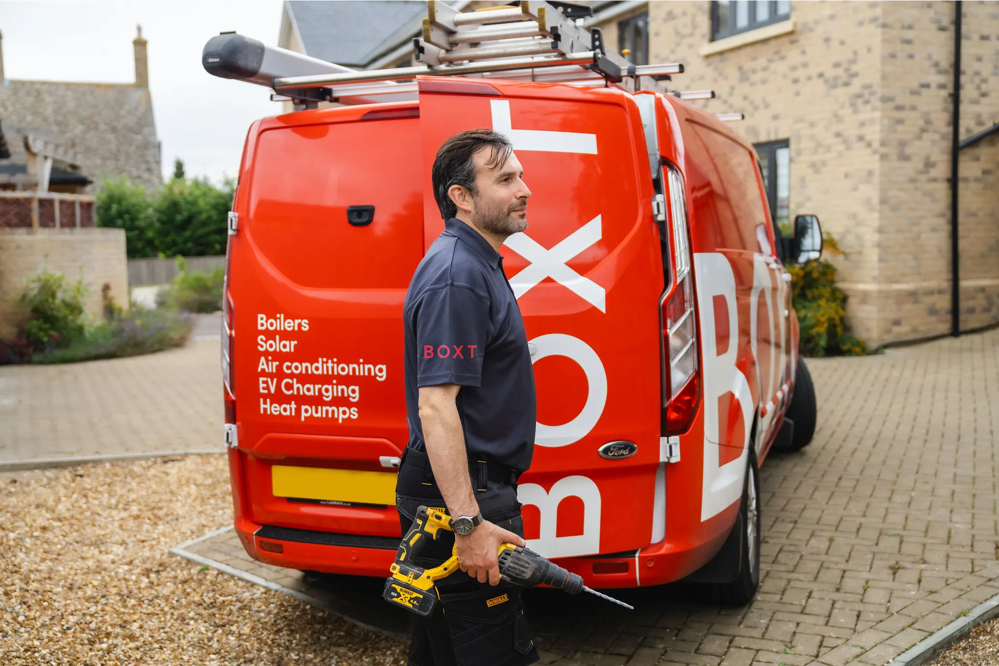 A BOXT engineer standing next to a BOXT van